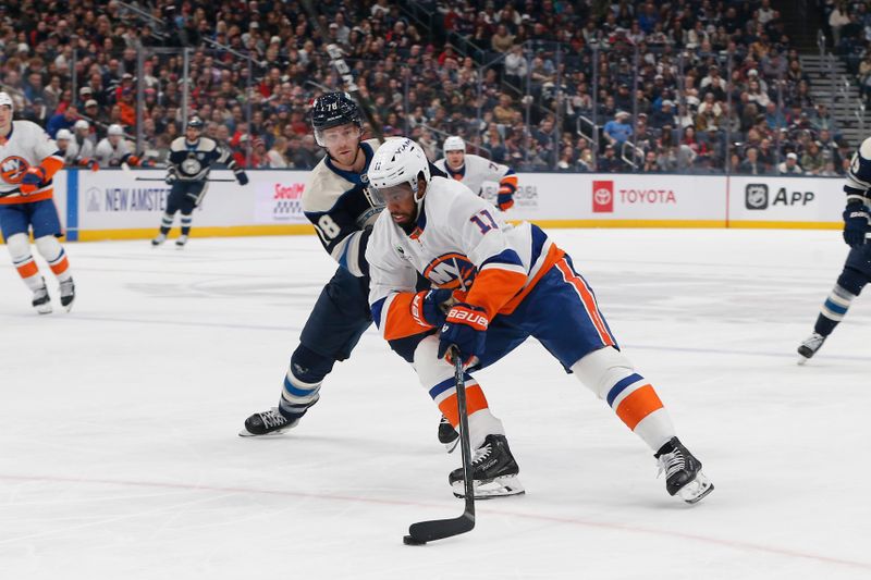 Dec 28, 2025; Columbus, Ohio, USA; New York Islanders left wing Anthony Duclair (11) carries the puck as Columbus Blue Jackets defenseman Damon Severson (78) defends during the first period at Nationwide Arena. Mandatory Credit: Russell LaBounty-Imagn Images
