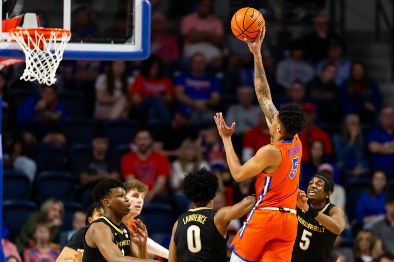 Feb 24, 2024; Gainesville, Florida, USA; Florida Gators guard Will Richard (5) shoots over Vanderbilt Commodores guard Tyrin Lawrence (0) during the first half at Exactech Arena at the Stephen C. O'Connell Center. Mandatory Credit: Matt Pendleton-USA TODAY Sports