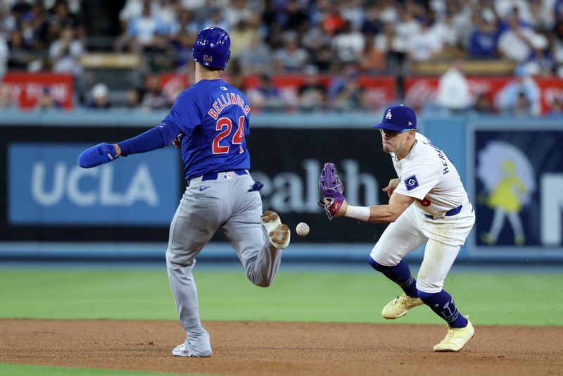 Sep 10, 2024; Los Angeles, California, USA;  Los Angeles Dodgers second baseman Enrique Hernandez (8) makes an error as he attempts to tag Chicago Cubs right fielder Cody Bellinger (24) during the eighth inning at Dodger Stadium. Mandatory Credit: Kiyoshi Mio-Imagn Images