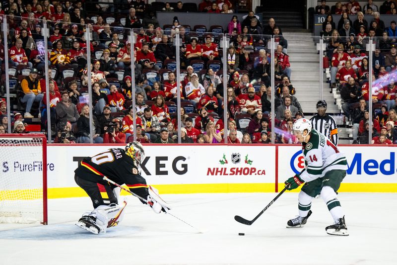 Nov 23, 2024; Calgary, Alberta, CAN; Calgary Flames goaltender Daniel Vladar (80) stops Minnesota Wild center Joel Eriksson Ek (14) during the shootout at Scotiabank Saddledome. Mandatory Credit: Brett Holmes-Imagn Images