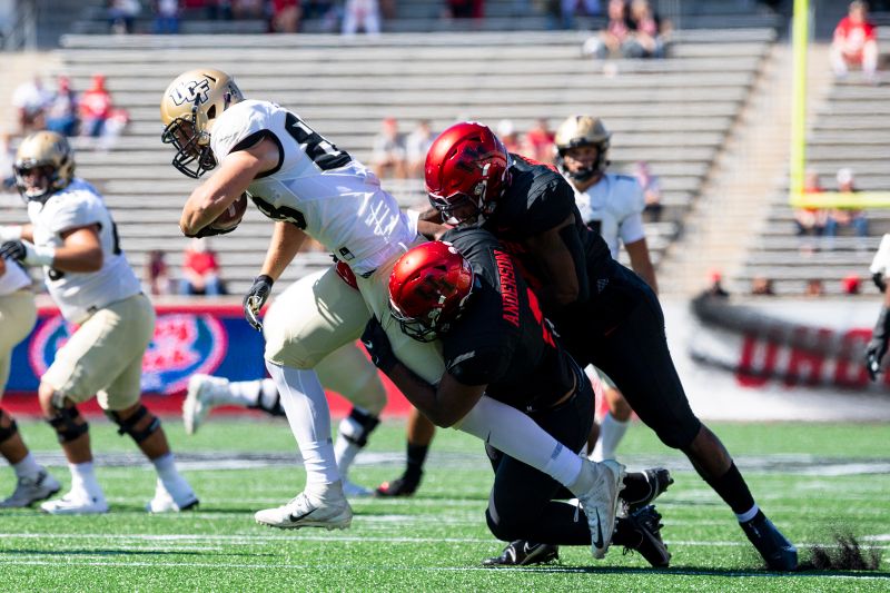 Oct 31, 2020; Houston, Texas, USA; Houston Cougars linebacker Keith Corbin (2) tackles UCF Knights tight end Jake Hescock (88) during the first quarter at TDECU Stadium. Mandatory Credit: Maria Lysaker-USA TODAY Sports