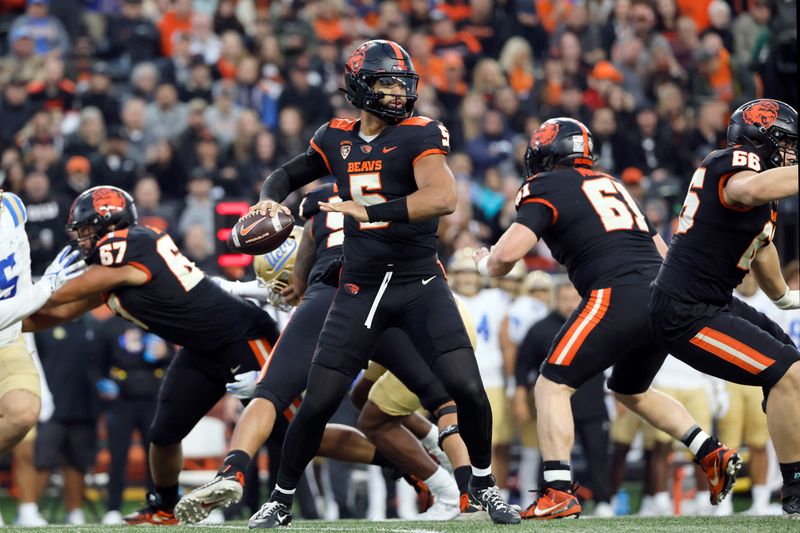 Oct 14, 2023; Corvallis, Oregon, USA; Oregon State Beavers quarterback DJ Uiagalelei (5) looks to throw during the first half against the UCLA Bruins at Reser Stadium. Mandatory Credit: Soobum Im-USA TODAY Sports