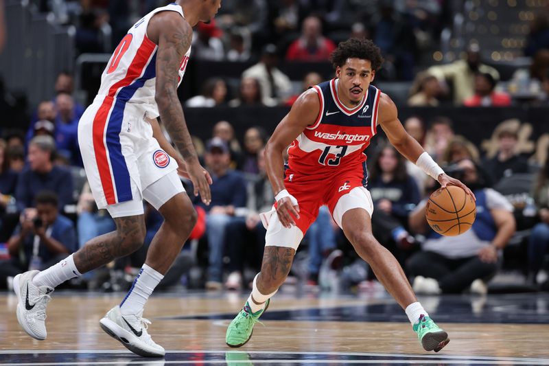 WASHINGTON, DC - NOVEMBER 17: Jordan Poole #13 of the Washington Wizards dribbles in front of Ronald Holland II #00 of the Detroit Pistons during the first half at Capital One Arena on November 17, 2024 in Washington, DC. NOTE TO USER: User expressly acknowledges and agrees that, by downloading and or using this photograph, User is consenting to the terms and conditions of the Getty Images License Agreement. (Photo by Patrick Smith/Getty Images)