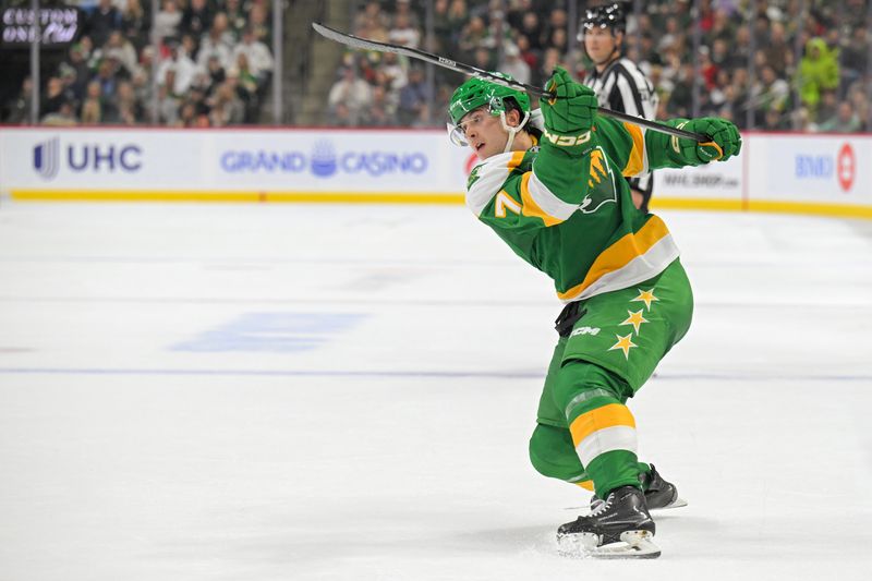 Oct 25, 2025; Saint Paul, Minnesota, USA;  Minnesota Wild defensemen Brock Faber (7) takes a shot against the Utah Mammoth during the second period at Grand Casino Arena. Mandatory Credit: Nick Wosika-Imagn Images