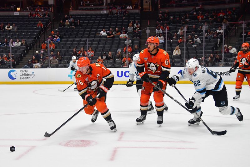 Sep 22, 2025; Anaheim, California, USA; Anaheim Ducks center Ryan Strome (16) moves the puck ahead of Utah Mammoth left wing Ben McCartney (62) during the third period at Honda Center. Mandatory Credit: Gary A. Vasquez-Imagn Images