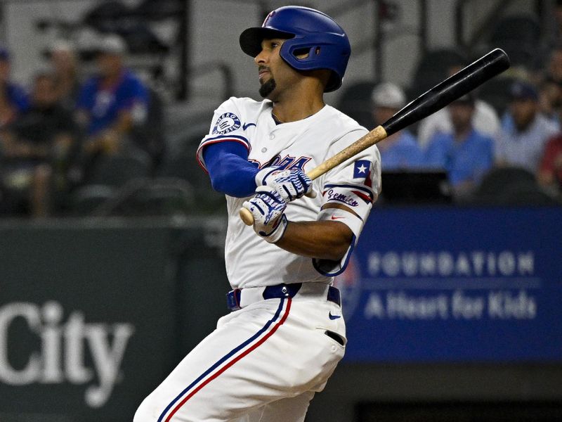 May 2, 2024; Arlington, Texas, USA; Texas Rangers second baseman Marcus Semien (2) hits a single and drives in a run against the Washington Nationals during the second inning at Globe Life Field. Mandatory Credit: Jerome Miron-USA TODAY Sports