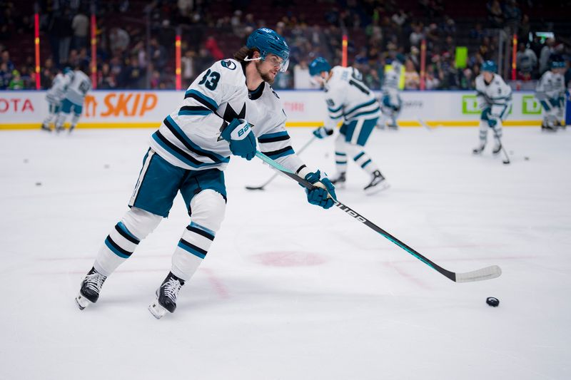 Dec 23, 2023; Vancouver, British Columbia, CAN; San Jose Sharks defenseman Nikita Okhotiuk (83) handles the puck during warm up prior to a game against the Vancouver Canucks at Rogers Arena. Mandatory Credit: Bob Frid-USA TODAY Sports