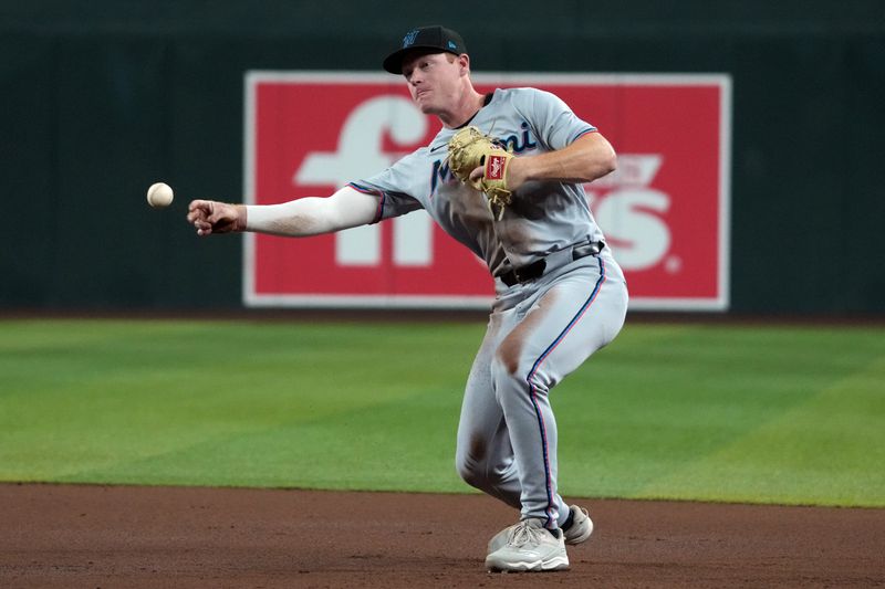 Jun 27, 2025; Phoenix, Arizona, USA; Miami Marlins first base Eric Wagaman (33) makes the play for an out against the Arizona Diamondbacks in the third inning at Chase Field. Mandatory Credit: Rick Scuteri-Imagn Images