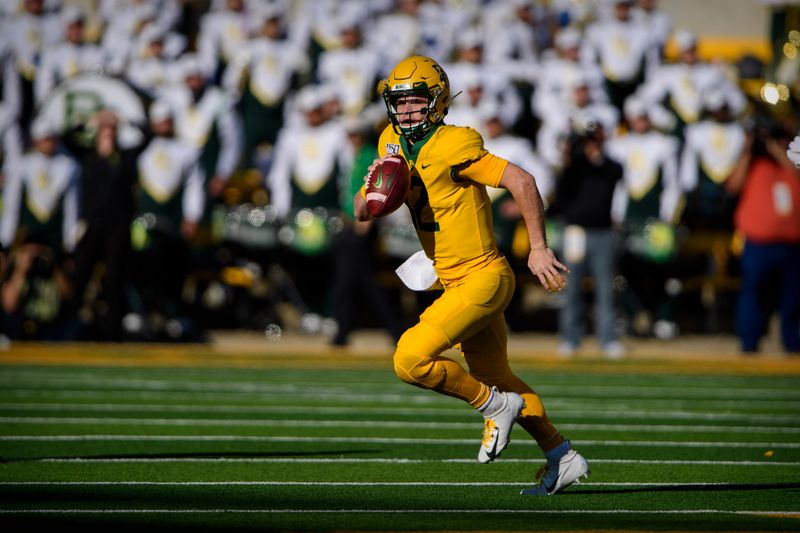Nov 23, 2019; Waco, TX, USA; Baylor Bears quarterback Charlie Brewer (12) rolls out against the Texas Longhorns during the first quarter at McLane Stadium. Mandatory Credit: Jerome Miron-USA TODAY Sports