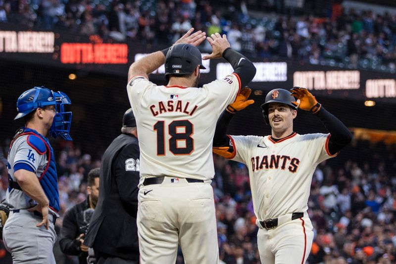 May 15, 2024; San Francisco, California, USA; San Francisco Giants right fielder Mike Yastrzemski (5) is congratulated by catcher Curt Casali (18) after he hit a two-run home run against the Los Angeles Dodgers during the third inning at Oracle Park. Mandatory Credit: John Hefti-USA TODAY Sports