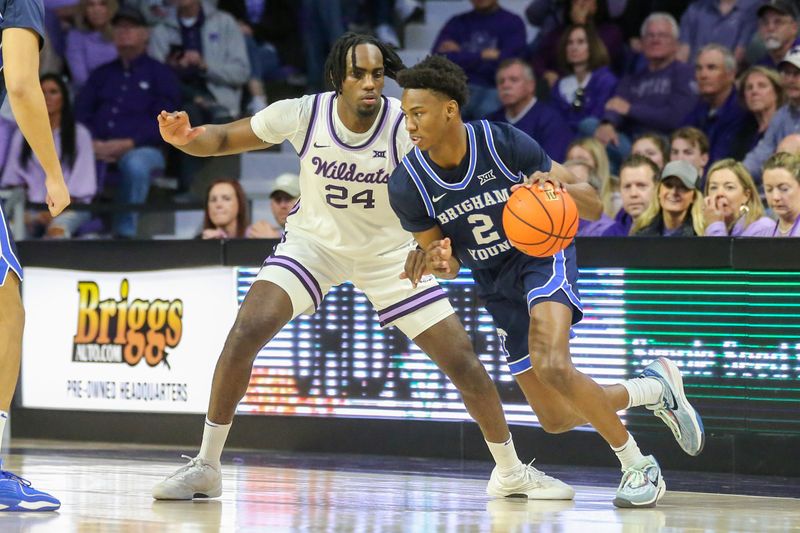 Feb 24, 2024; Manhattan, Kansas, USA; Brigham Young Cougars guard Jaxson Robinson (2) dribbles against Kansas State Wildcats forward Arthur Maluma (24) during the first half at Bramlage Coliseum. Mandatory Credit: Scott Sewell-USA TODAY Sports