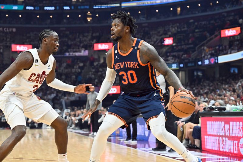 CLEVELAND, OHIO - APRIL 15: Caris LeVert #3 of the Cleveland Cavaliers guards Julius Randle #30 of the New York Knicks during the first quarter of Game One of the Eastern Conference First Round Playoffs at Rocket Mortgage Fieldhouse on April 15, 2023 in Cleveland, Ohio. NOTE TO USER: User expressly acknowledges and agrees that, by downloading and or using this photograph, User is consenting to the terms and conditions of the Getty Images License Agreement. (Photo by Jason Miller/Getty Images)