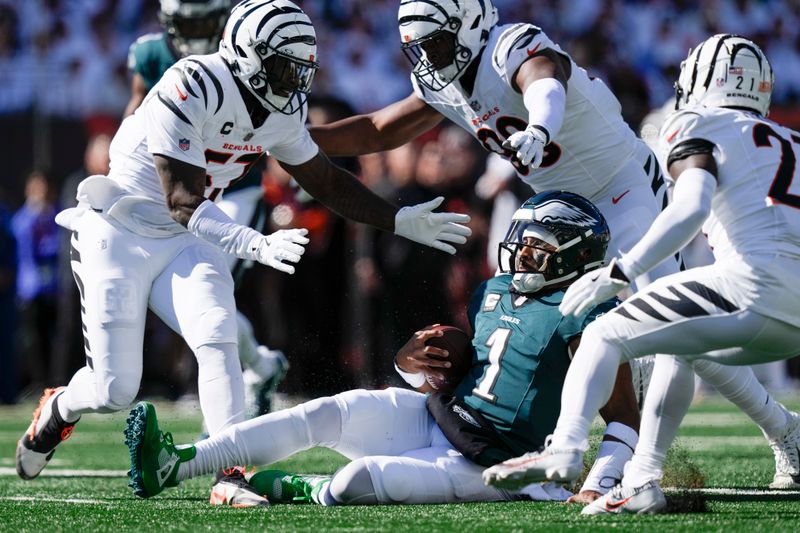 Philadelphia Eagles quarterback Jalen Hurts (1) slides down after running for yardage against the Cincinnati Bengals during the first half of an NFL football game, Sunday, Oct. 27, 2024 in Cincinnati. (AP Photo/Carolyn Kaster)