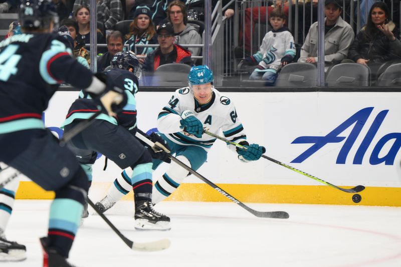 Nov 30, 2024; Seattle, Washington, USA; San Jose Sharks center Mikael Granlund (64) passes the puck against the Seattle Kraken during the first period at Climate Pledge Arena. Mandatory Credit: Steven Bisig-Imagn Images