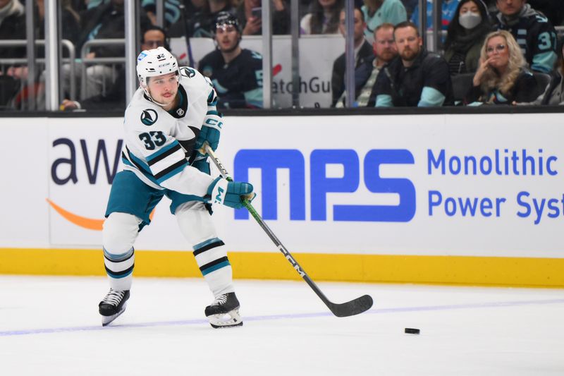 Nov 22, 2023; Seattle, Washington, USA; San Jose Sharks defenseman Calen Addison (33) passes the puck against the San Jose Sharks during the first period at Climate Pledge Arena. Mandatory Credit: Steven Bisig-USA TODAY Sports