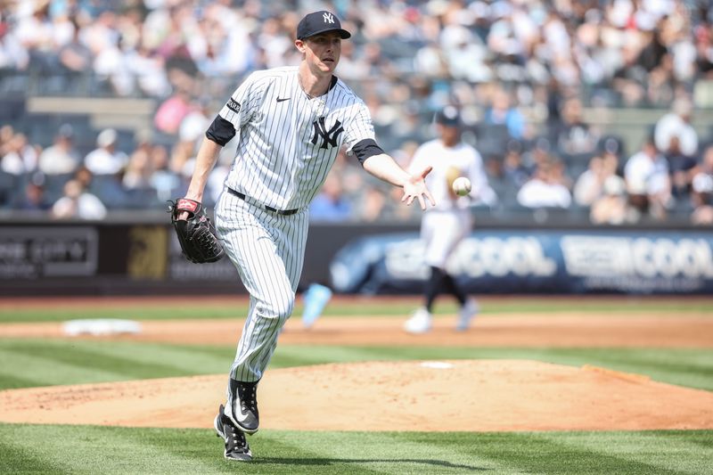 May 3, 2025; Bronx, New York, USA;  New York Yankees starting pitcher Ryan Yarbrough (33) flips the ball to first base for an assist in the second inning against the Tampa Bay Rays at Yankee Stadium. Mandatory Credit: Wendell Cruz-Imagn Images