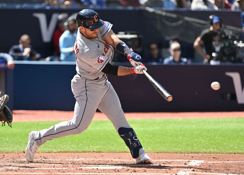 Aug 27, 2023; Toronto, Ontario, CAN; Cleveland Guardians right fielder Ramon Laureano (10) hits a single against the Toronto Blue Jays in the fourth inning at Rogers Centre. Mandatory Credit: Dan Hamilton-USA TODAY Sports