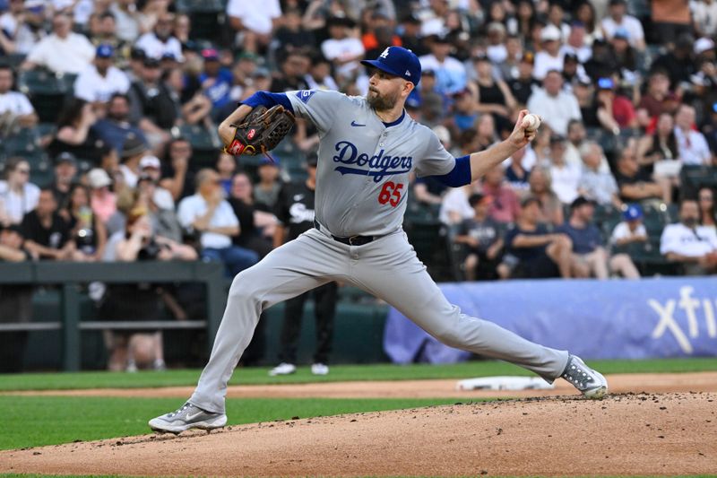 Jun 24, 2024; Chicago, Illinois, USA;  Los Angeles Dodgers hitting coach Aaron Bates (65) delivers against the Chicago White Sox in the first inning at Guaranteed Rate Field. Mandatory Credit: Matt Marton-USA TODAY Sports