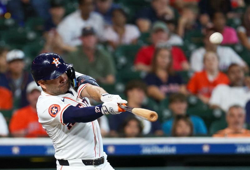 Jul 30, 2025; Houston, Texas, USA; Houston Astros second baseman Jose Altuve (27) hits a three run home run against the Washington Nationals in the second inning at Daikin Park. Mandatory Credit: Thomas Shea-Imagn Images
