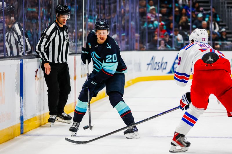 Nov 17, 2024; Seattle, Washington, USA; Seattle Kraken right wing Eeli Tolvanen (20) passes the puck against the New York Rangers during the first period at Climate Pledge Arena. Mandatory Credit: Joe Nicholson-Imagn Images