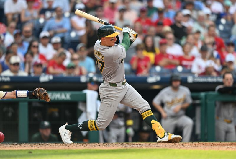 Jul 13, 2024; Philadelphia, Pennsylvania, USA; Oakland Athletics third baseman Brett Harris (77) hits an RBI single against the Philadelphia Phillies in the seventh inning at Citizens Bank Park. Mandatory Credit: Kyle Ross-USA TODAY Sports