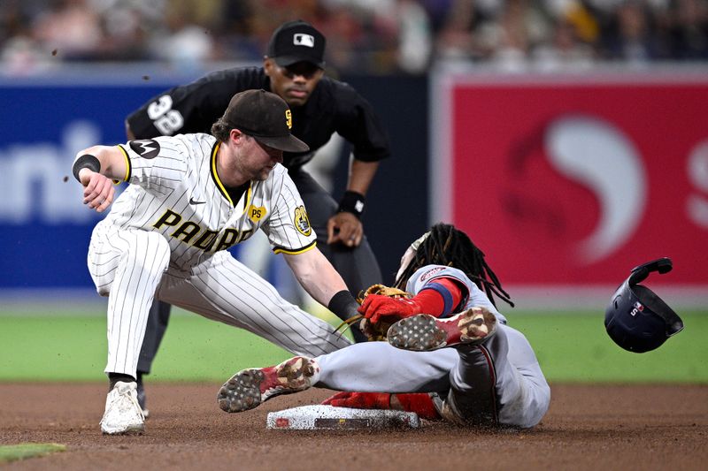 Jun 24, 2024; San Diego, California, USA; Washington Nationals shortstop CJ Abrams (5) steals second base ahead of the tag by San Diego Padres second baseman Jake Cronenworth (9) during the seventh inning at Petco Park. Mandatory Credit: Orlando Ramirez-USA TODAY Sports