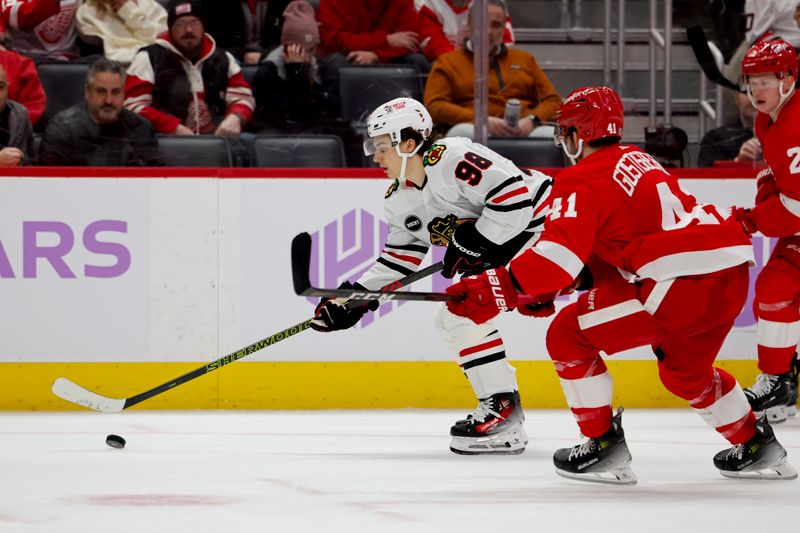 Nov 30, 2023; Detroit, Michigan, USA; Chicago Blackhawks center Connor Bedard (98) skates with the puck defended by Detroit Red Wings defenseman Shayne Gostisbehere (41) in the third period at Little Caesars Arena. Mandatory Credit: Rick Osentoski-USA TODAY Sports