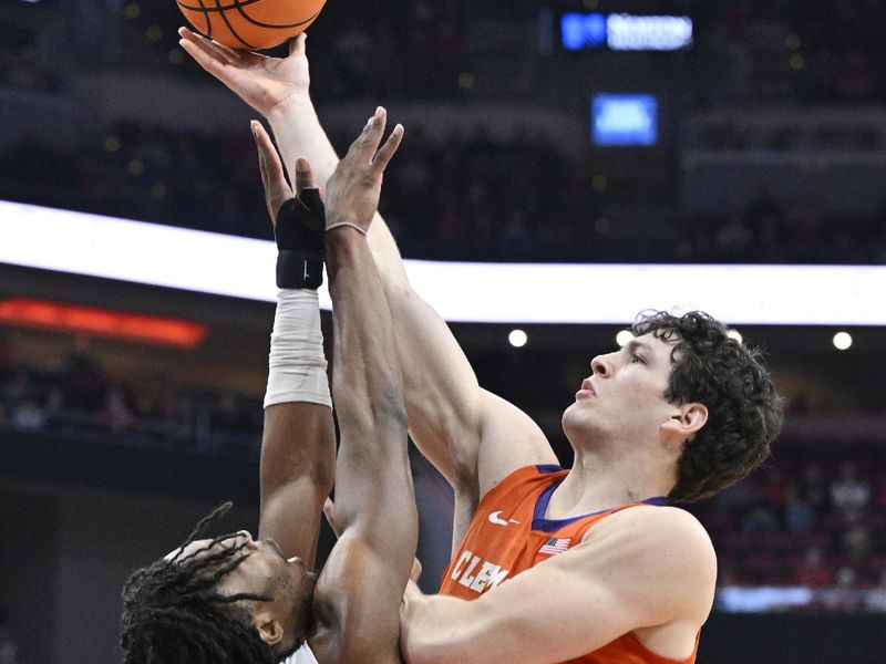 Feb 18, 2023; Louisville, Kentucky, USA;  Clemson Tigers center PJ Hall (24) shoots against Louisville Cardinals forward Jae'Lyn Withers (24) during the first half at KFC Yum! Center. Mandatory Credit: Jamie Rhodes-USA TODAY Sports