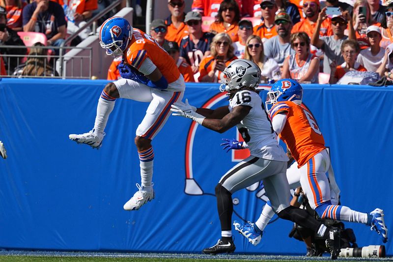 Denver Broncos cornerback Pat Surtain II (2) returns an interception for 100 yards against the Las Vegas Raiders in the second quarter of an NFL football game Sunday October 6, 2024, in Denver. (AP Photo/Bart Young)