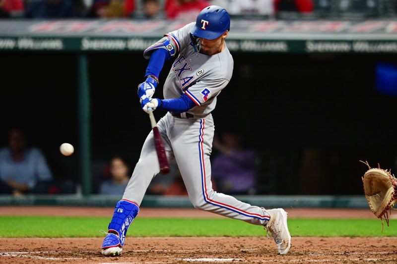 Sep 15, 2023; Cleveland, Ohio, USA; Texas Rangers center fielder Evan Carter (32) hits a double during the third inning against the Cleveland Guardians at Progressive Field. Mandatory Credit: Ken Blaze-USA TODAY Sports