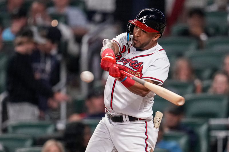 Apr 12, 2023; Cumberland, Georgia, USA; Atlanta Braves left fielder Eddie Rosario (8) hits a home run against the Cincinnati Reds during the eighth inning at Truist Park. Mandatory Credit: Dale Zanine-USA TODAY Sports