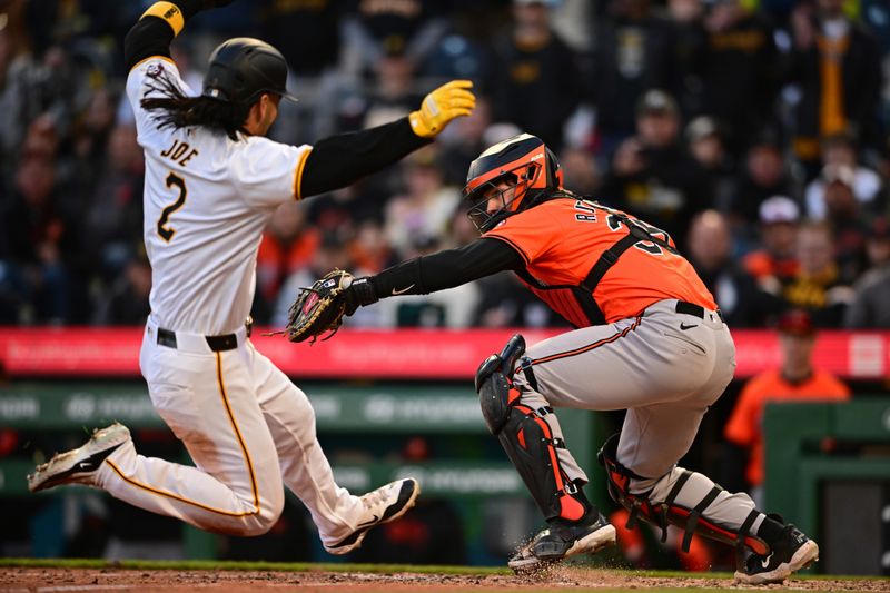 Apr 6, 2024; Pittsburgh, Pennsylvania, USA; Baltimore Orioles catcher Adley Rutschman (35) forces out Pittsburgh Pirates right fielder Connor Joe (2) during the tenth inning at PNC Park. Mandatory Credit: David Dermer-USA TODAY Sports