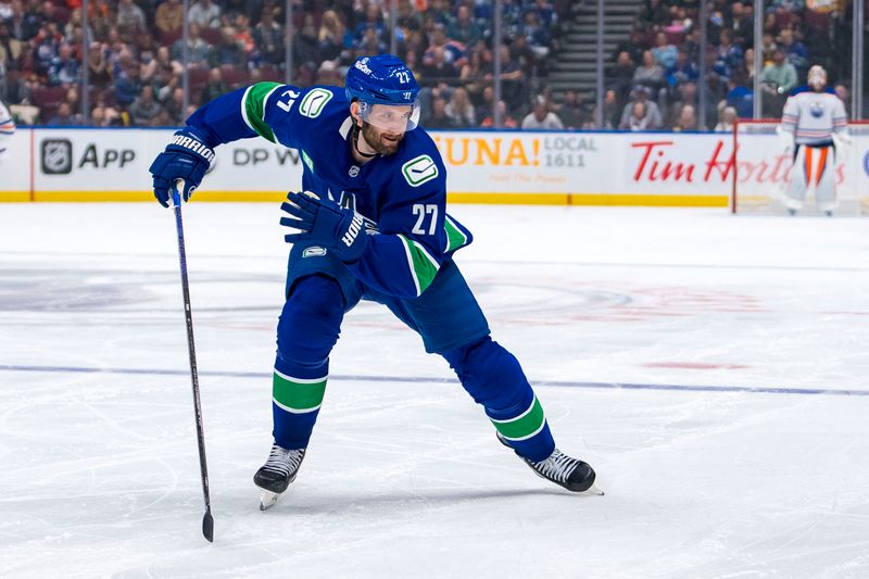 Oct 4, 2024; Vancouver, British Columbia, CAN; Vancouver Canucks defenseman Derek Forbort (27) skates against the Edmonton Oilers during the second period at Rogers Arena. Mandatory Credit: Bob Frid-Imagn Images