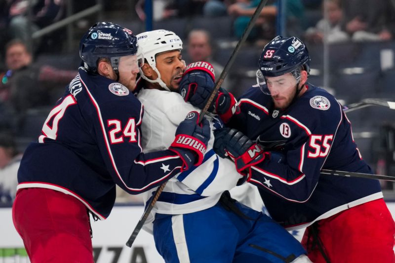 Oct 22, 2024; Columbus, Ohio, USA;  Toronto Maple Leafs right wing Ryan Reaves, middle, scrums with Columbus Blue Jackets right wing Mathieu Olivier, left, and defenseman David Jiricek, right, during the third period at Nationwide Arena. Mandatory Credit: Aaron Doster-Imagn Images