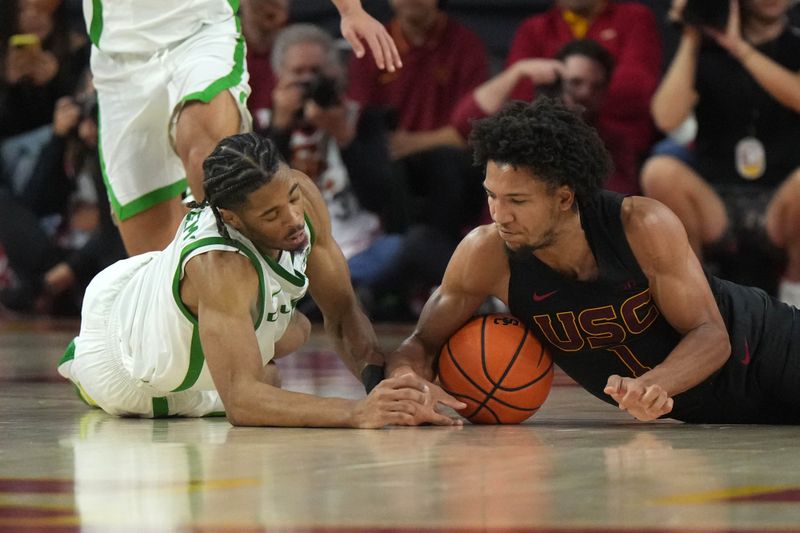 Dec 4, 2024; Los Angeles, California, USA; Southern California Trojans guard Desmond Claude (1) and Oregon Ducks guard Keeshawn Barthelemy (9) reach for the ball in the second half at Galen Center. Mandatory Credit: Kirby Lee-Imagn ImagesDec 4, 2024; Los Angeles, California, USA; at Galen Center. Mandatory Credit: Kirby Lee-Imagn Images