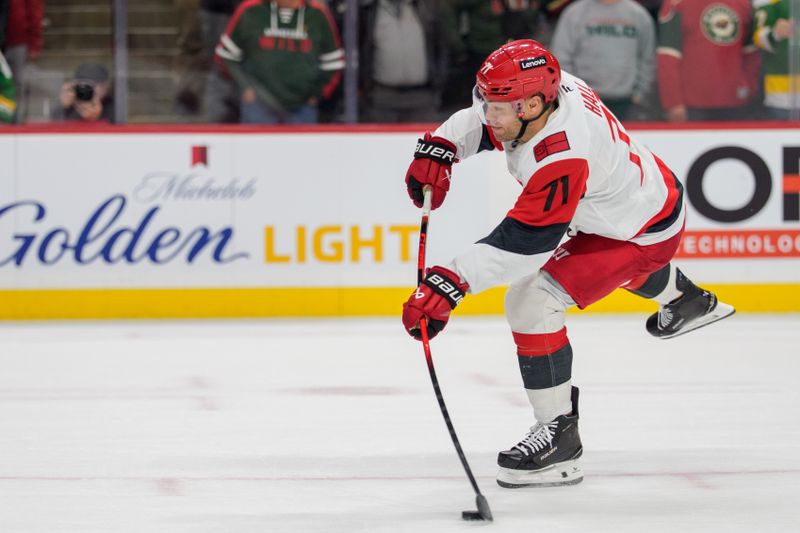 Nov 19, 2025; Saint Paul, Minnesota, USA; Carolina Hurricanes left wing Taylor Hall (71) shoots against Minnesota Wild goaltender Jesper Wallstedt (30) in the overtime shootout at Grand Casino Arena. Mandatory Credit: Matt Blewett-Imagn Images