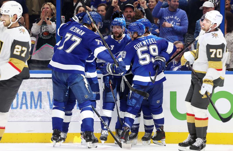 Oct 17, 2024; Tampa, Florida, USA; Tampa Bay Lightning right wing Nikita Kucherov (86) celebrates with defenseman Victor Hedman (77),  center Jake Guentzel (59) and teammates  after he scored a goal against the Vegas Golden Knights during the first period at Amalie Arena. Mandatory Credit: Kim Klement Neitzel-Imagn Images