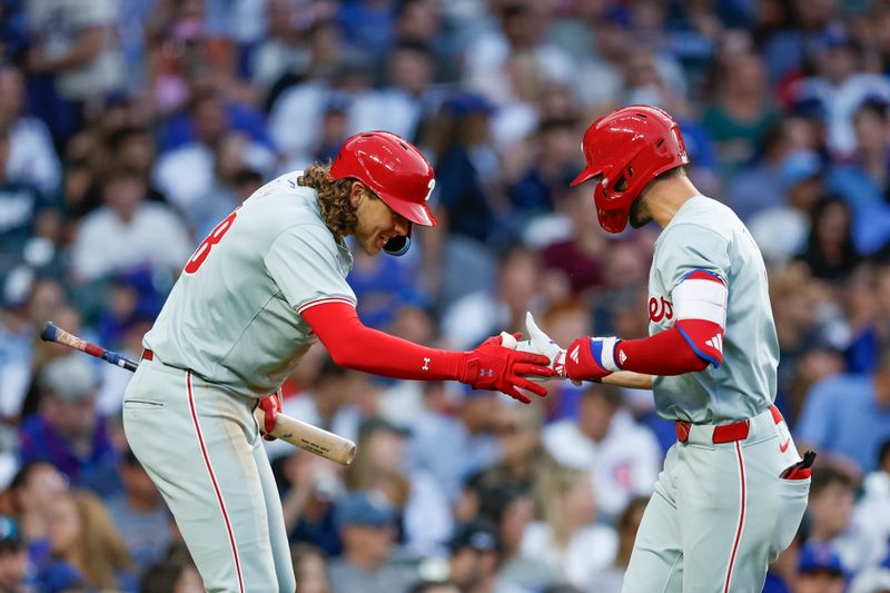 Jul 2, 2024; Chicago, Illinois, USA; Philadelphia Phillies shortstop Trea Turner (7) celebrates with third baseman Alec Bohm (28) after hitting a solo home run against the Chicago Cubs during the third inning at Wrigley Field. Mandatory Credit: Kamil Krzaczynski-USA TODAY Sports