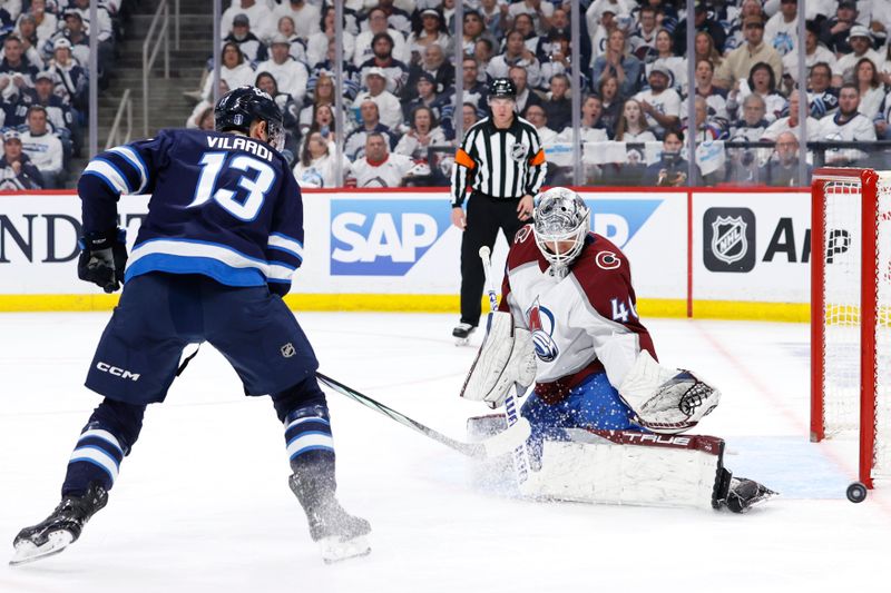 Apr 30, 2024; Winnipeg, Manitoba, CAN; Colorado Avalanche goaltender Alexandar Georgiev (40) stops a shot by Winnipeg Jets center Gabriel Vilardi (13) in the second period in game five of the first round of the 2024 Stanley Cup Playoffs at Canada Life Centre. Mandatory Credit: James Carey Lauder-USA TODAY Sports