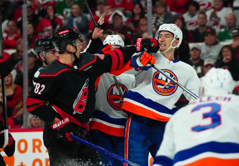 Apr 22, 2024; Raleigh, North Carolina, USA; New York Islanders center Brock Nelson (29) and Carolina Hurricanes center Jesperi Kotkaniemi (82) battle during the first period in game two of the first round of the 2024 Stanley Cup Playoffs at PNC Arena. Mandatory Credit: James Guillory-USA TODAY Sports