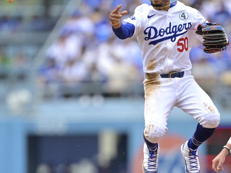 Jun 2, 2024; Los Angeles, California, USA;  Los Angeles Dodgers shortstop Mookie Betts (50) throws to first after a getting Colorado Rockies outfielder Hunter Goodman (15) out at second in the fifth inning at Dodger Stadium. Mandatory Credit: Jayne Kamin-Oncea-USA TODAY Sports