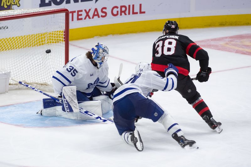 Sep 24, 2024; Ottawa, Ontario, CAN; Ottawa Senators center Zack Ostapchuk (38) scores a short-handed goal against Toronto Maple Leafs goalie Dennis Hildeby (35) in the third period at the Canadian Tire Centre. Mandatory Credit: Marc DesRosiers-Imagn Images