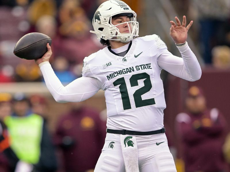 Oct 28, 2023; Minneapolis, Minnesota, USA; Michigan State Spartans quarterback Katin Houser (12) throws for a 34-yard completion against the Minnesota Golden Gophers during the second quarter at Huntington Bank Stadium. Mandatory Credit: Nick Wosika-USA TODAY Sports