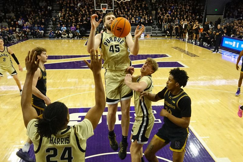 Mar 4, 2026; Evanston, Illinois, USA; Purdue Boilermakers center Oscar Cluff (45) goes for a rebound against the Northwestern Wildcats during the second half at Welsh-Ryan Arena. Mandatory Credit: David Banks-Imagn Images