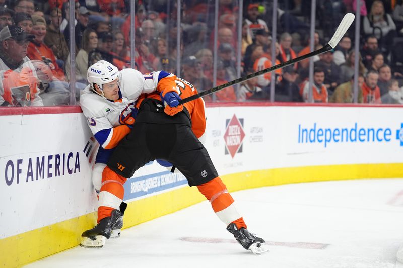 Oct 25, 2025; Philadelphia, Pennsylvania, USA; Philadelphia Flyers defenseman Travis Sanheim (6) hits New York Islanders center Mathew Barzal (13) in the first period at Xfinity Mobile Arena. Mandatory Credit: Kyle Ross-Imagn Images