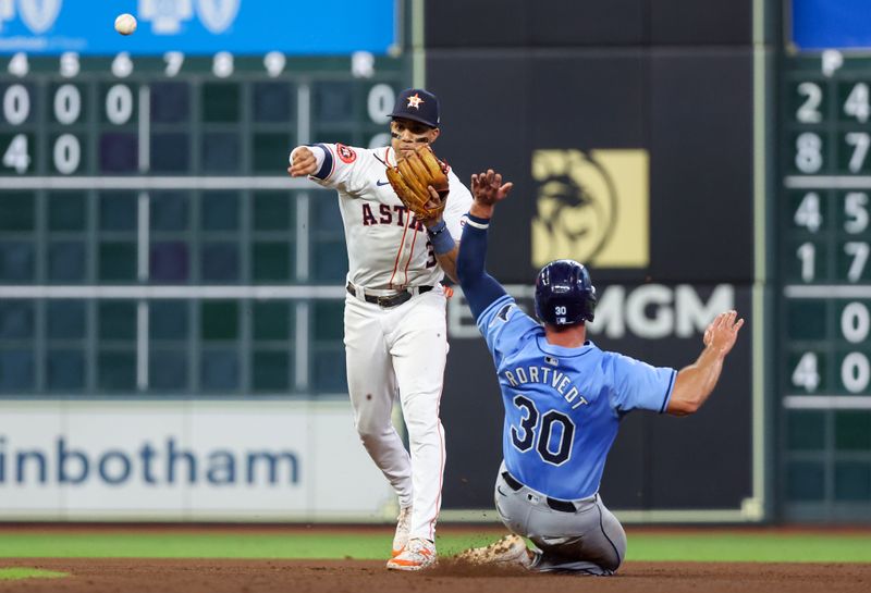 Aug 3, 2024; Houston, Texas, USA; Tampa Bay Rays catcher Ben Rortvedt (30) is forced out at second base by Houston Astros shortstop Jeremy Pena (3) in the sixth inning at Minute Maid Park. Mandatory Credit: Thomas Shea-USA TODAY Sports