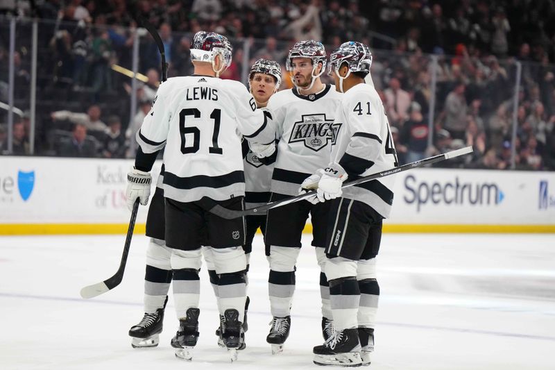 Apr 13, 2024; Los Angeles, California, USA; LA Kings defenseman Matt Roy (3) celebrates with center Blake Lizotte (46), center Akil Thomas (41) and center Trevor Lewis (61)after scoring a goal against the Anaheim Ducks in the second period at Crypto.com Arena. Mandatory Credit: Kirby Lee-USA TODAY Sports