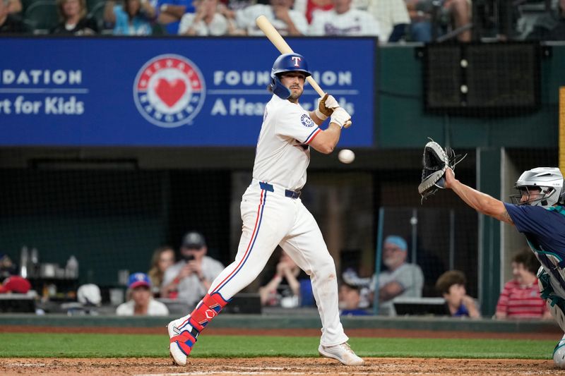 Apr 24, 2024; Arlington, Texas, USA; Texas Rangers third baseman Josh Smith (8) is hit by a pitch thrown by Seattle Mariners pitcher Tayler Saucedo (60) during the sixth inning at Globe Life Field. Mandatory Credit: Jim Cowsert-USA TODAY Sports