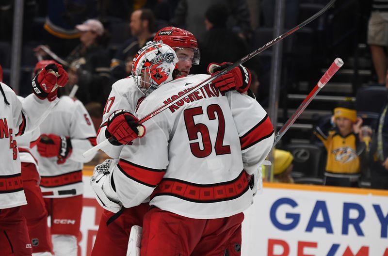 Dec 27, 2023; Nashville, Tennessee, USA; Carolina Hurricanes goaltender Pyotr Kochetkov (52) and right wing Andrei Svechnikov (37) celebrate after a win against the Nashville Predators at Bridgestone Arena. Mandatory Credit: Christopher Hanewinckel-USA TODAY Sports