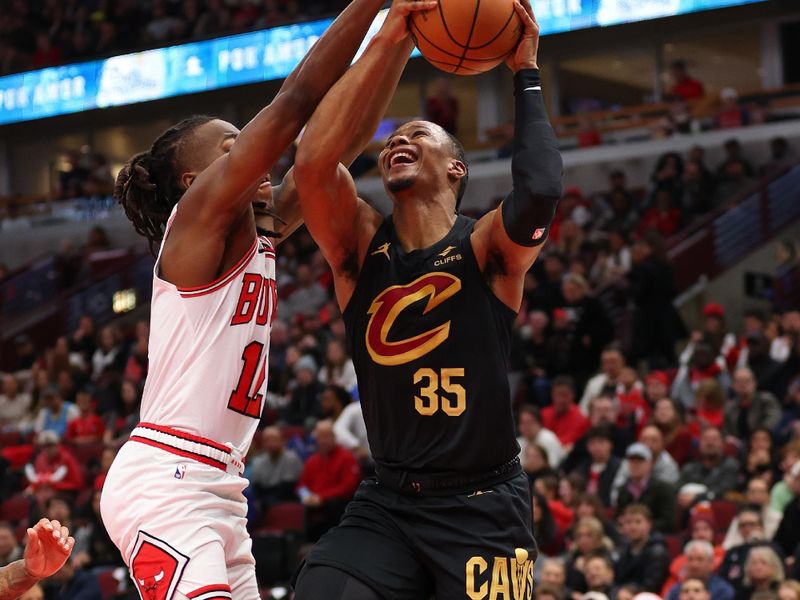 CHICAGO, ILLINOIS - DECEMBER 23: Isaac Okoro #35 of the Cleveland Cavaliers goes up for a layup against Ayo Dosunmu #12 of the Chicago Bulls during the first half at the United Center on December 23, 2023 in Chicago, Illinois. NOTE TO USER: User expressly acknowledges and agrees that, by downloading and or using this photograph, User is consenting to the terms and conditions of the Getty Images License Agreement.  (Photo by Michael Reaves/Getty Images)